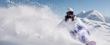 Skier emerging through powder snow in the closing shot