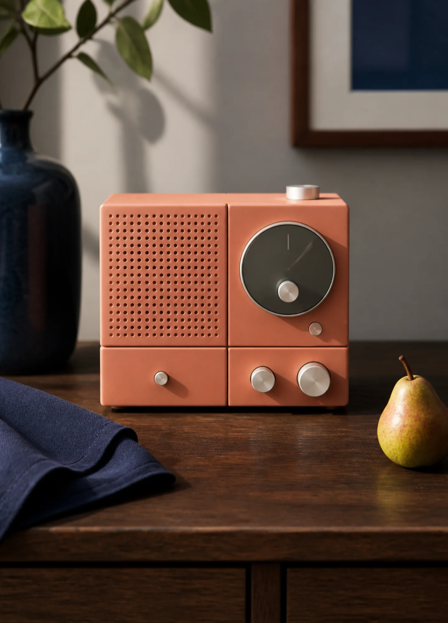 a coral ceramic desk radio photographed with refined material detail