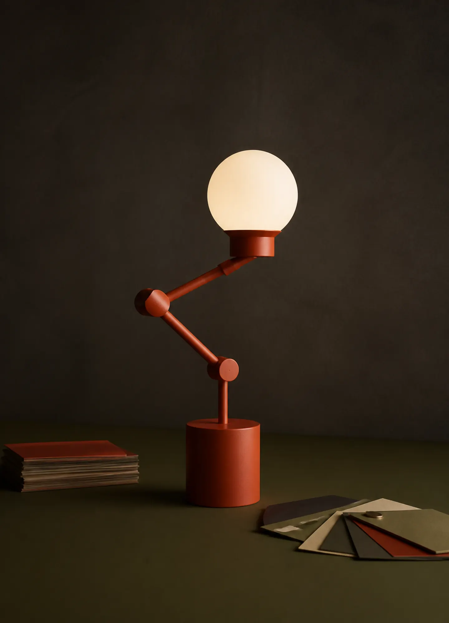 a vermilion modular lamp photographed as an industrial-design still life